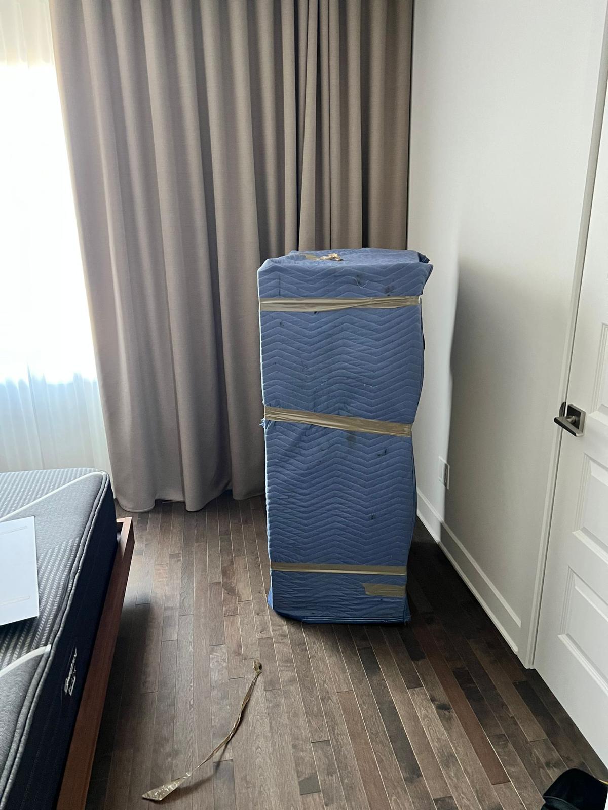 Furniture wrapped in moving blankets by Déménagement NST movers